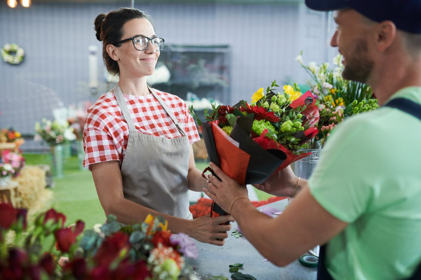 Photo of florist giving free flowers to customer